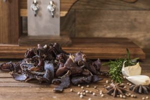Table with a Biltong cutting board chopping up dried meat that we can Biltong in South Africa